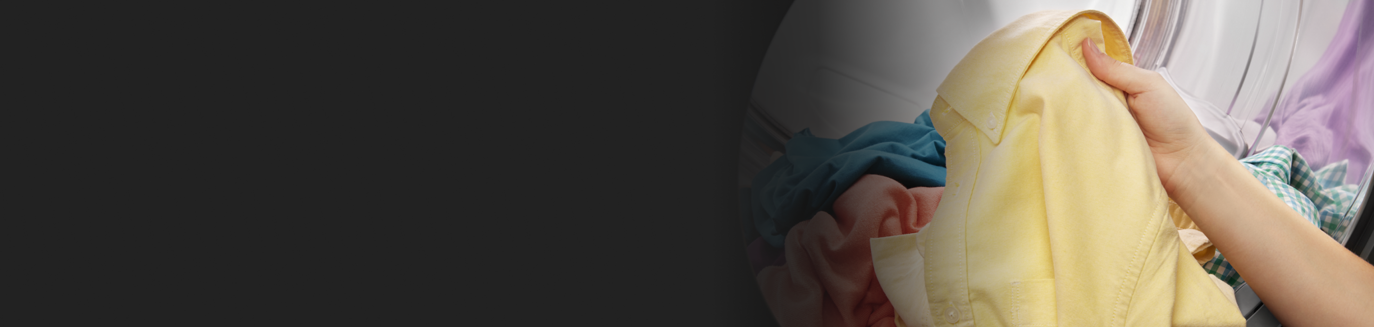 Person removing yellow shirt from dryer