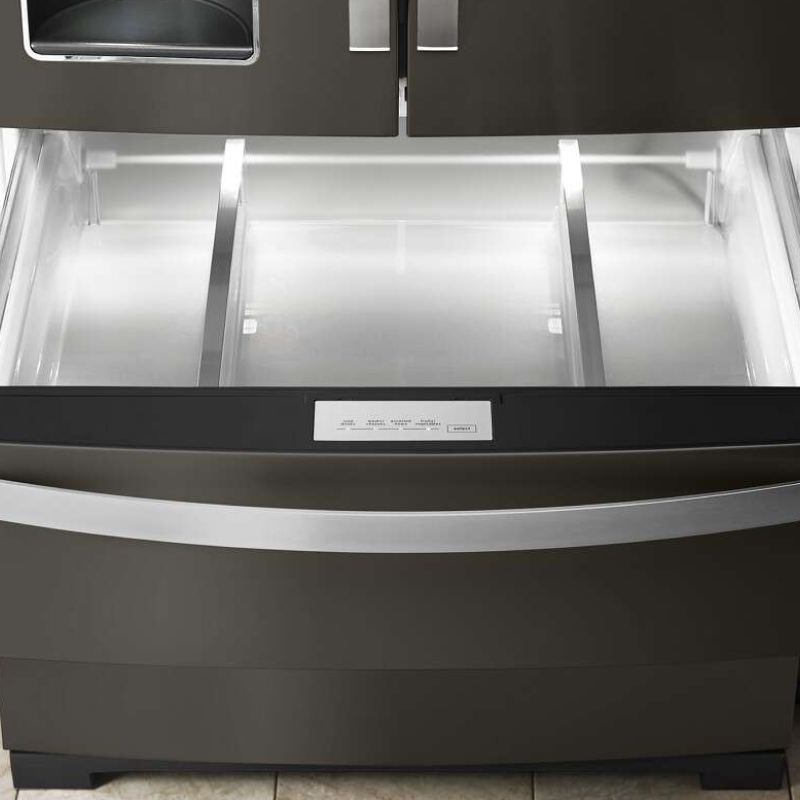 Empty bottom freezer drawer pulled out with LED lighting activated