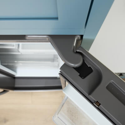 Close-up of top of counter-depth refrigerator aligning with cabinetry