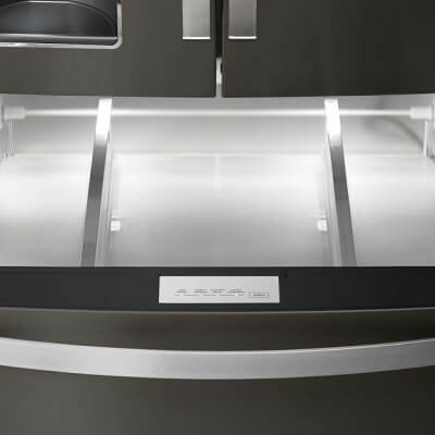 Empty bottom freezer drawer pulled out with LED lighting activated