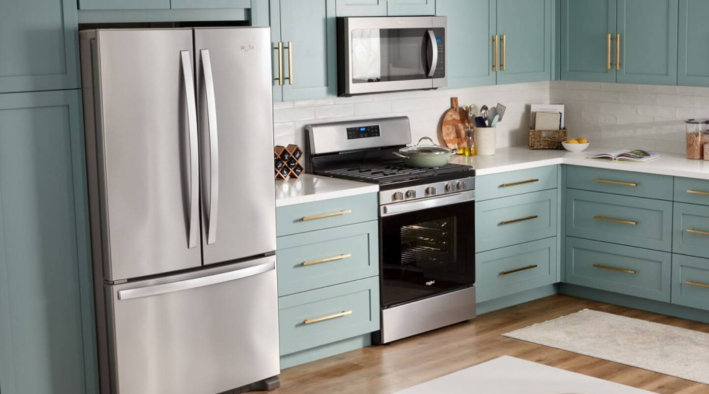 Whirlpool® Stainless Steel French door Refrigerator in baby blue cabinetry with gold cabinet pulls
