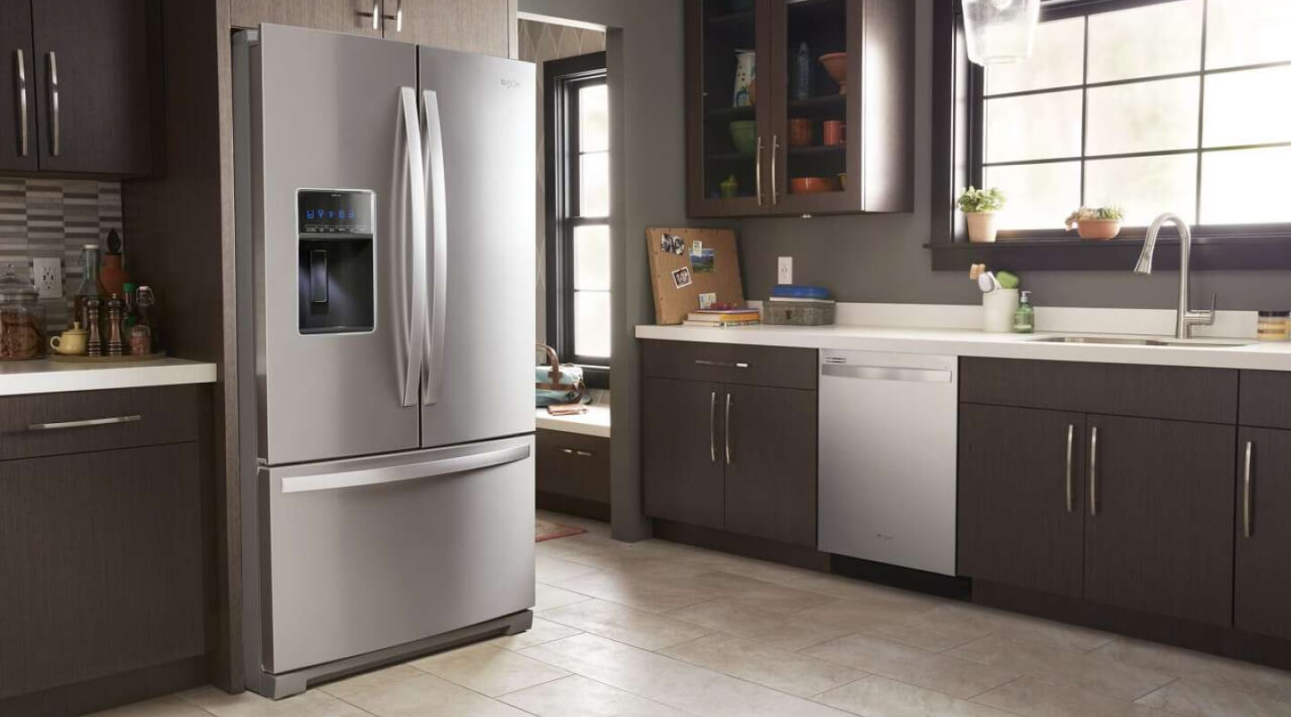 Whirlpool® French Door Refrigerator in kitchen with brown cabinetry