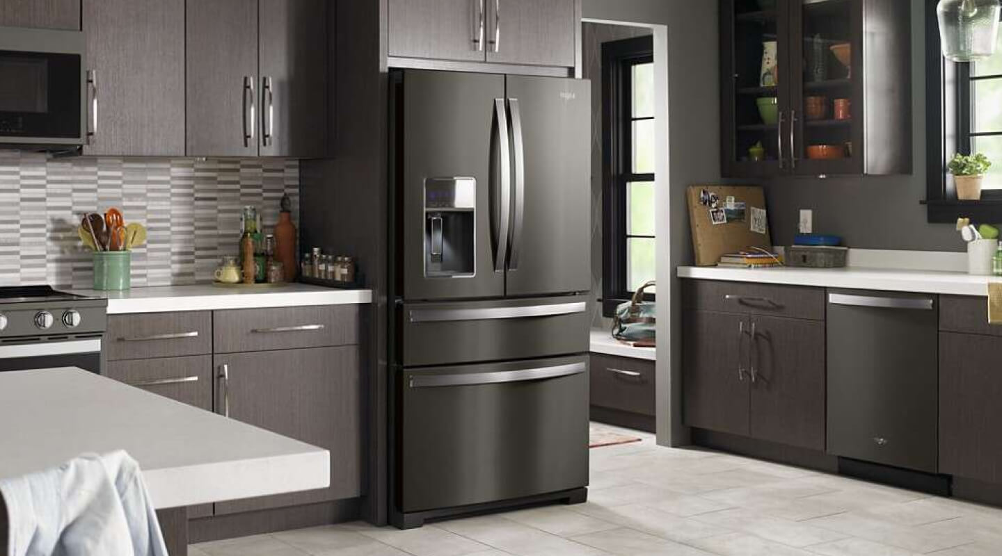 Black stainless Whirlpool® French Door Refrigerator in a modern kitchen with brown cabinets