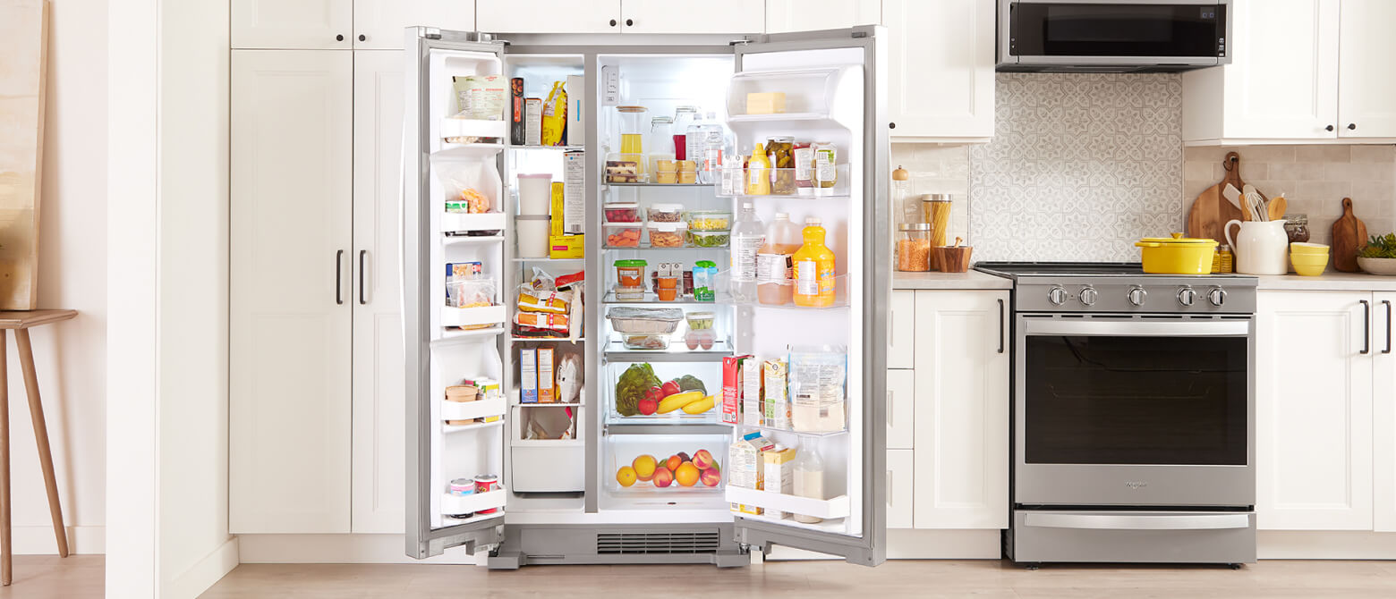 A side-by-side refrigerator with both doors opened to reveal a fully stocked interior