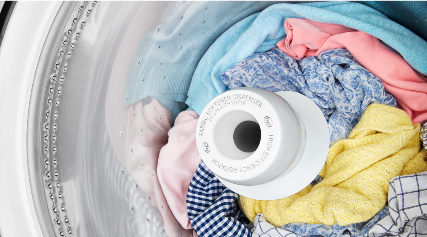Clothes inside a top loading washing machine Clothes inside a top loading washing machine