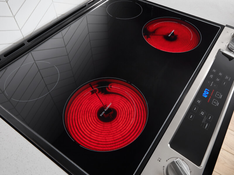 A glass surface stovetop with two burners warm