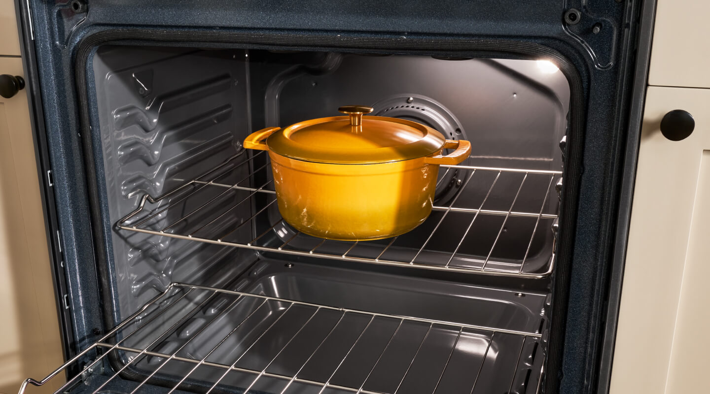A Dutch Oven pot sitting in an open oven