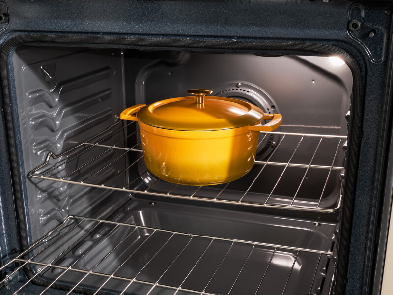 A Dutch Oven pot sitting in an open oven
