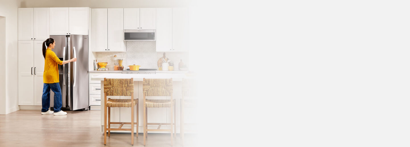 Person opening a side-by-side refrigerator