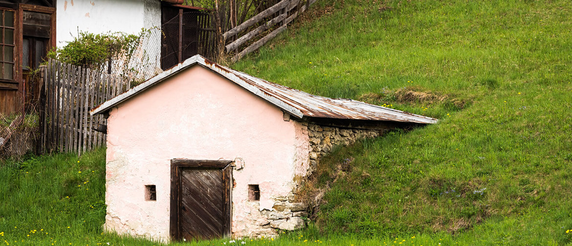 A cold cellar built into a hill beside a house