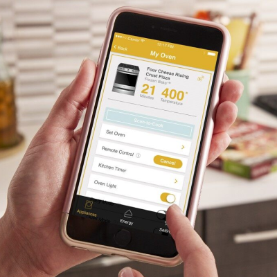 Person preheating oven remotely on the app