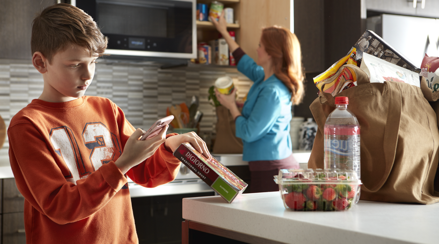 Person scanning a food barcode with a phone