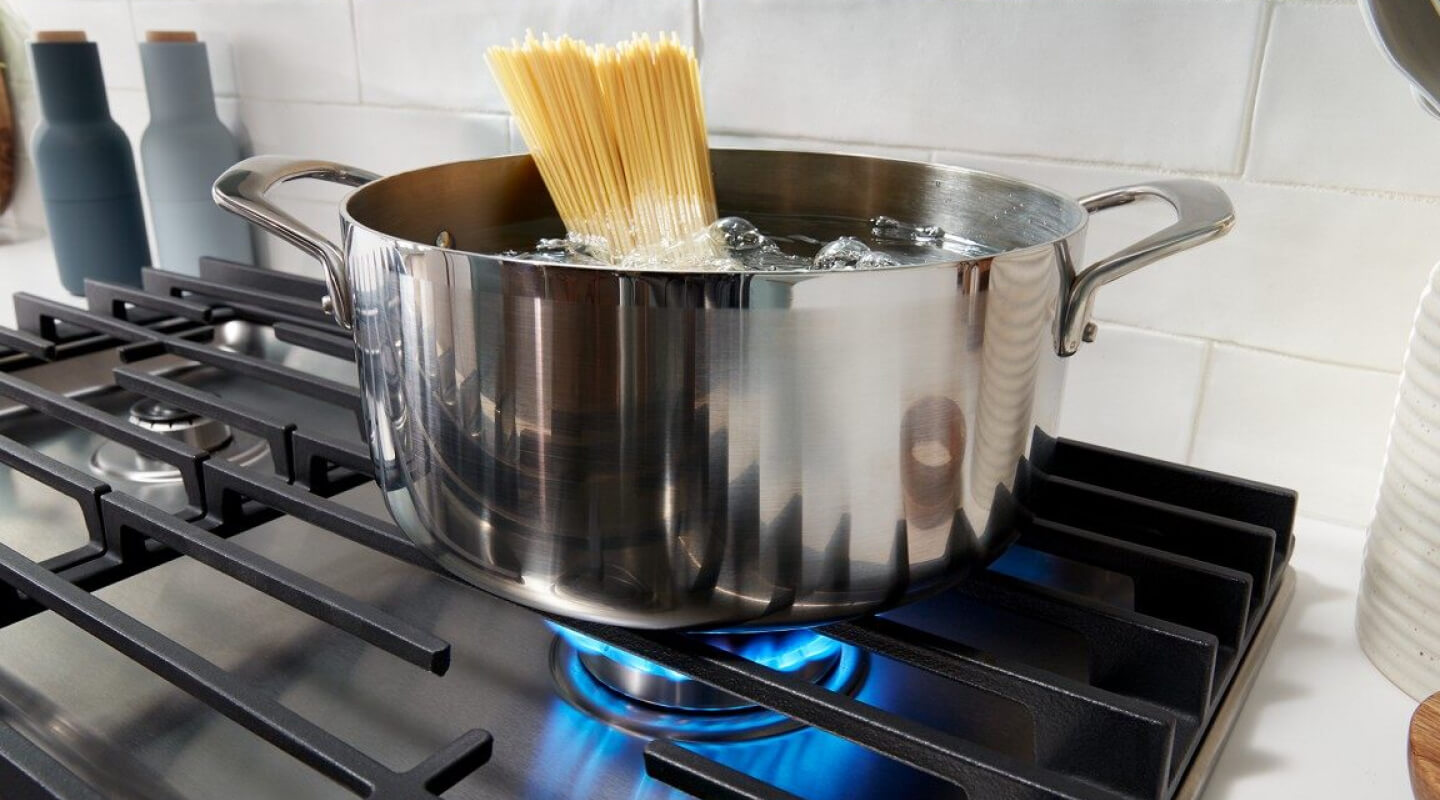 Pasta cooking in a pot on a gas cooktop Pasta cooking in a pot on a gas cooktop