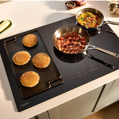 Breakfast cooking on an electric cooktop with griddle accessory
