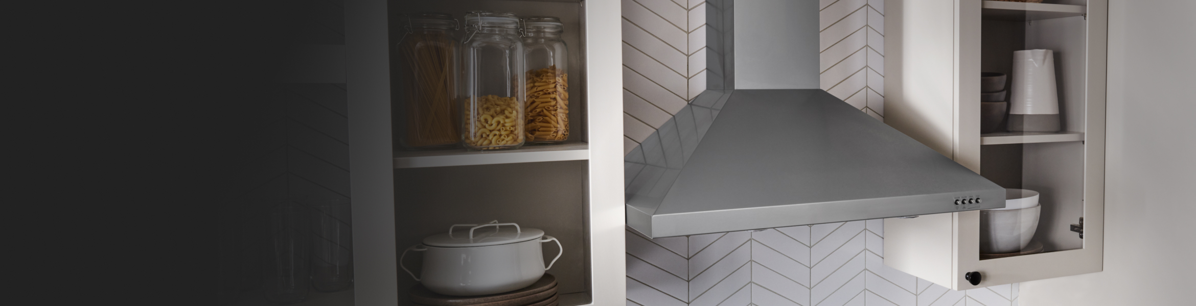 A canopy hood installed between cabinets.