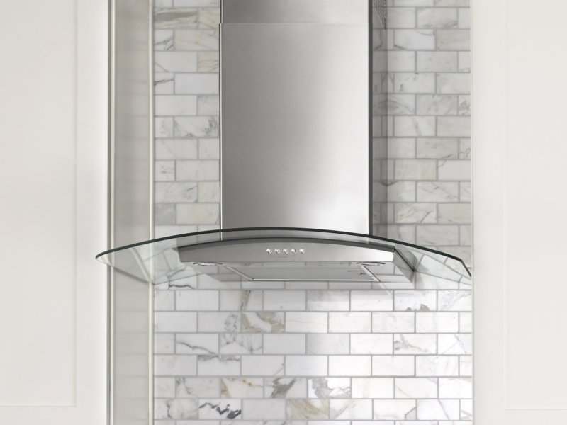 Glass-edged wall-mounted canopy hood between cabinets Glass-edged wall-mounted canopy hood between cabinets