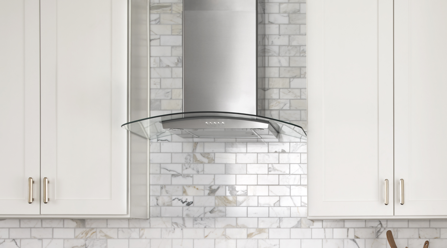 Glass-edged wall-mounted canopy hood between cabinets Glass-edged wall-mounted canopy hood between cabinets