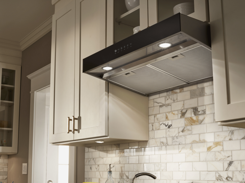 Under-cabinet hood installed beneath modern wood cabinets Under-cabinet hood installed beneath modern wood cabinets