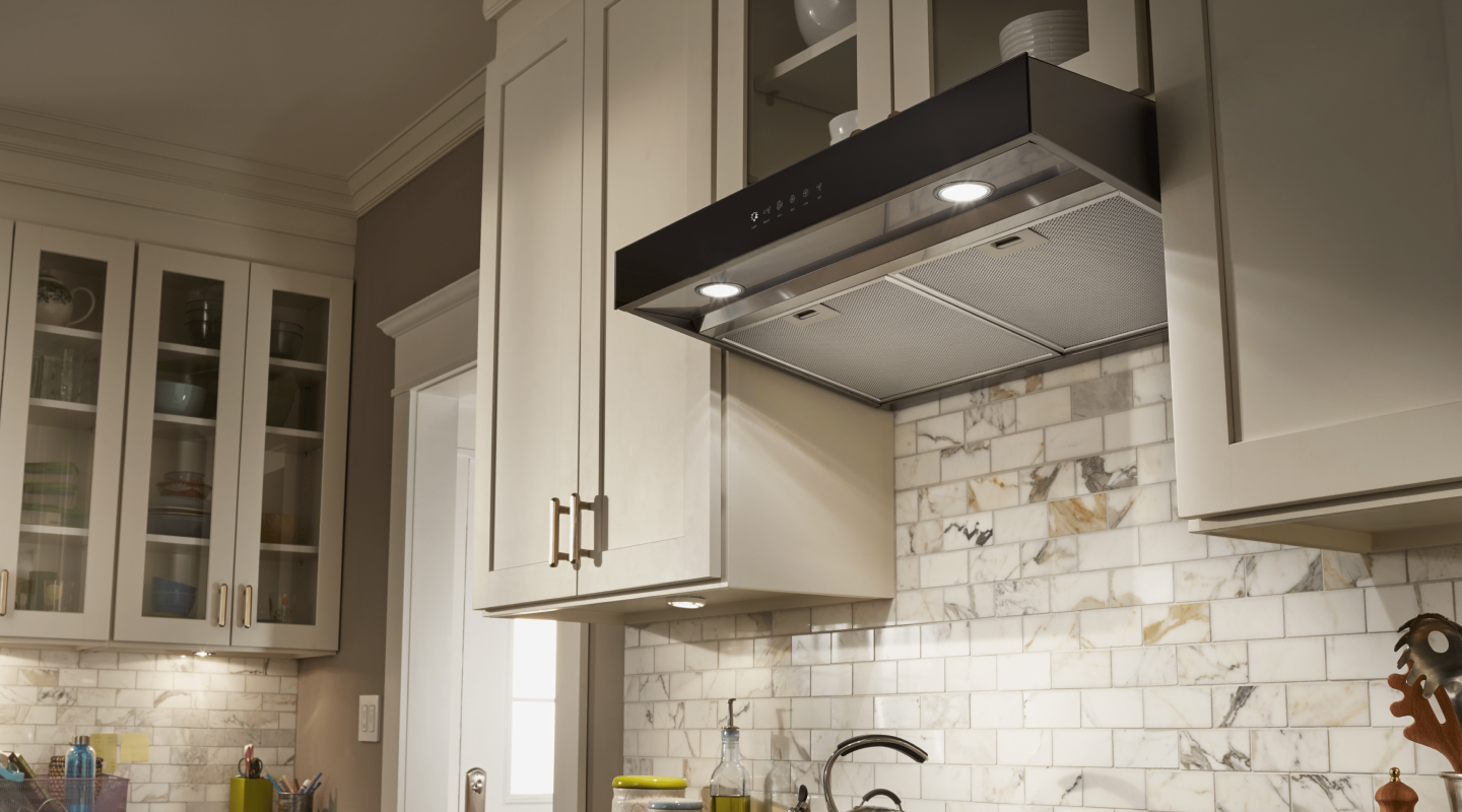 Under-cabinet hood installed beneath modern wood cabinets Under-cabinet hood installed beneath modern wood cabinets