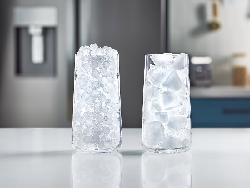 A glass full of nugget ice next to a glass full of traditional ice