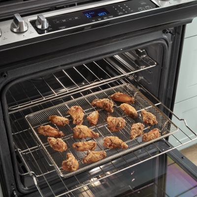 Chicken wings cooking in an air fry oven