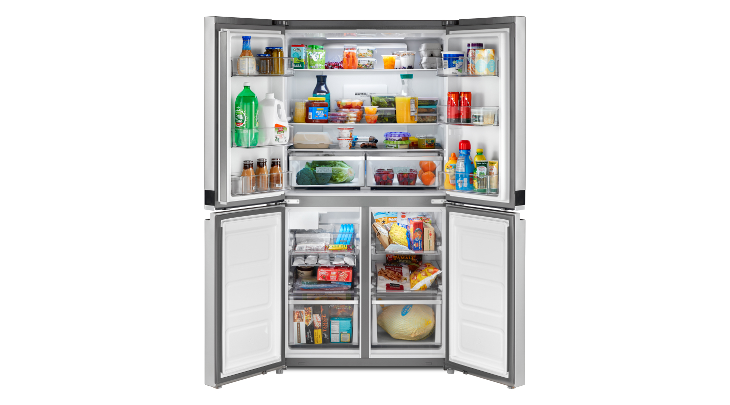Four door refrigerator opened to show contents Four door refrigerator opened to show contents