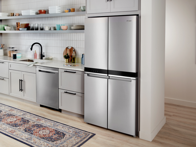 Stainless steel four-door refrigerator set in white cabinetry Stainless steel four-door refrigerator set in white cabinetry
