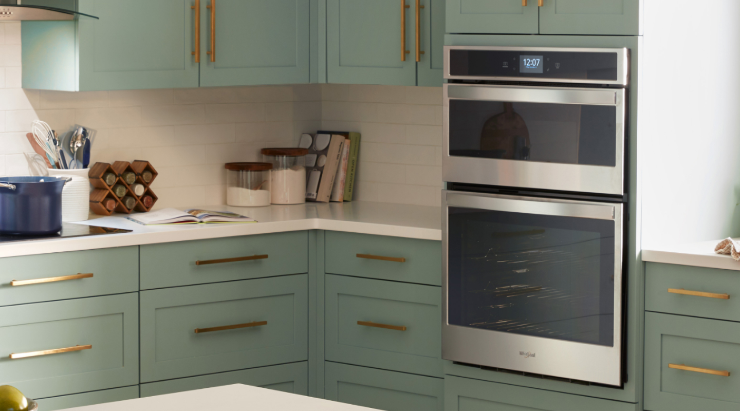 A double wall oven in a kitchen with green cabinetry A double wall oven in a kitchen with green cabinetry