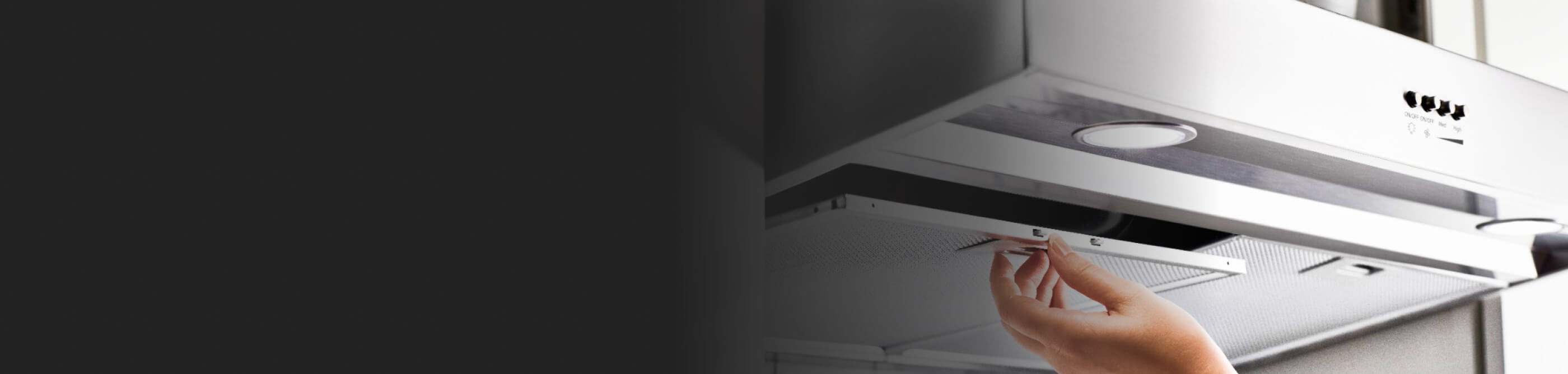 A hand removing the filter on a Whirlpool® Range Hood