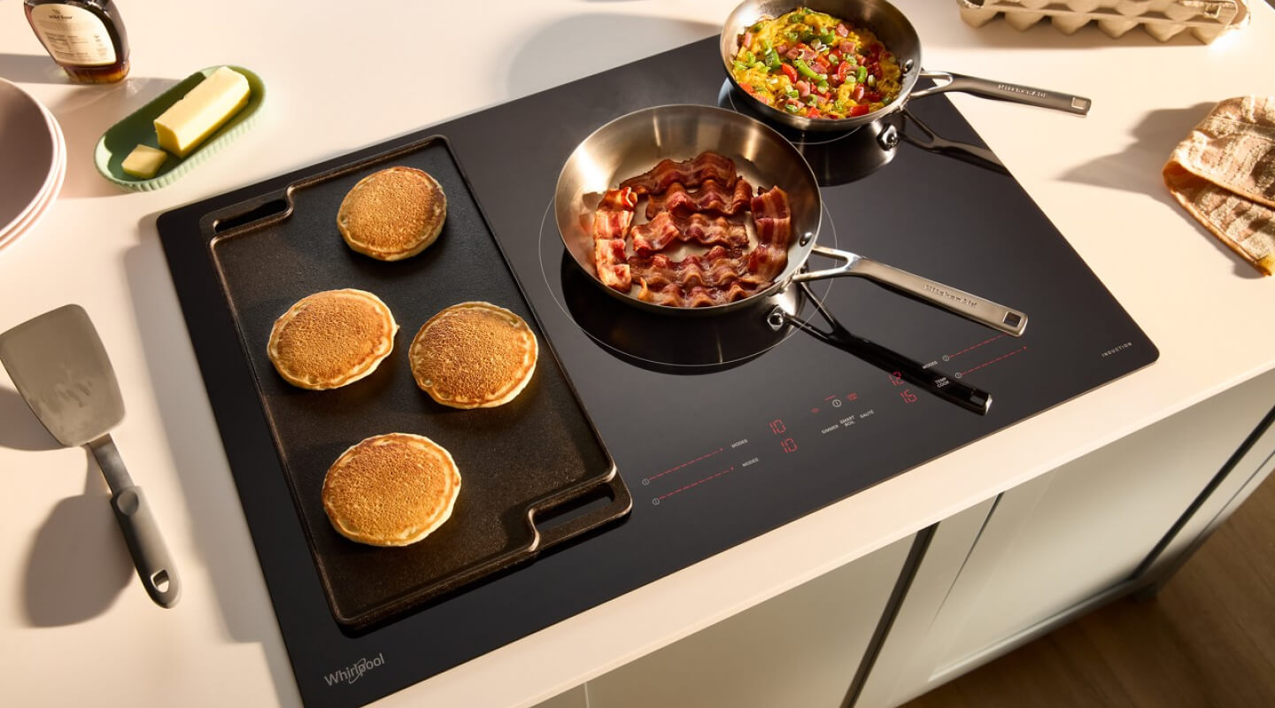 A griddle and a saucepan on an electric cooktop