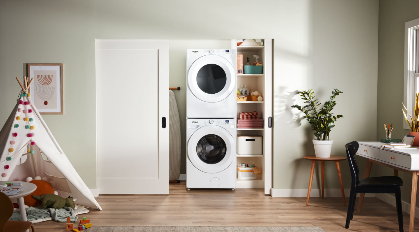  A laundry area with a stackable Whirlpool® Washer and Dryer