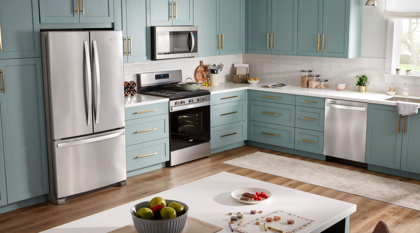Teal and white kitchen island with three stools