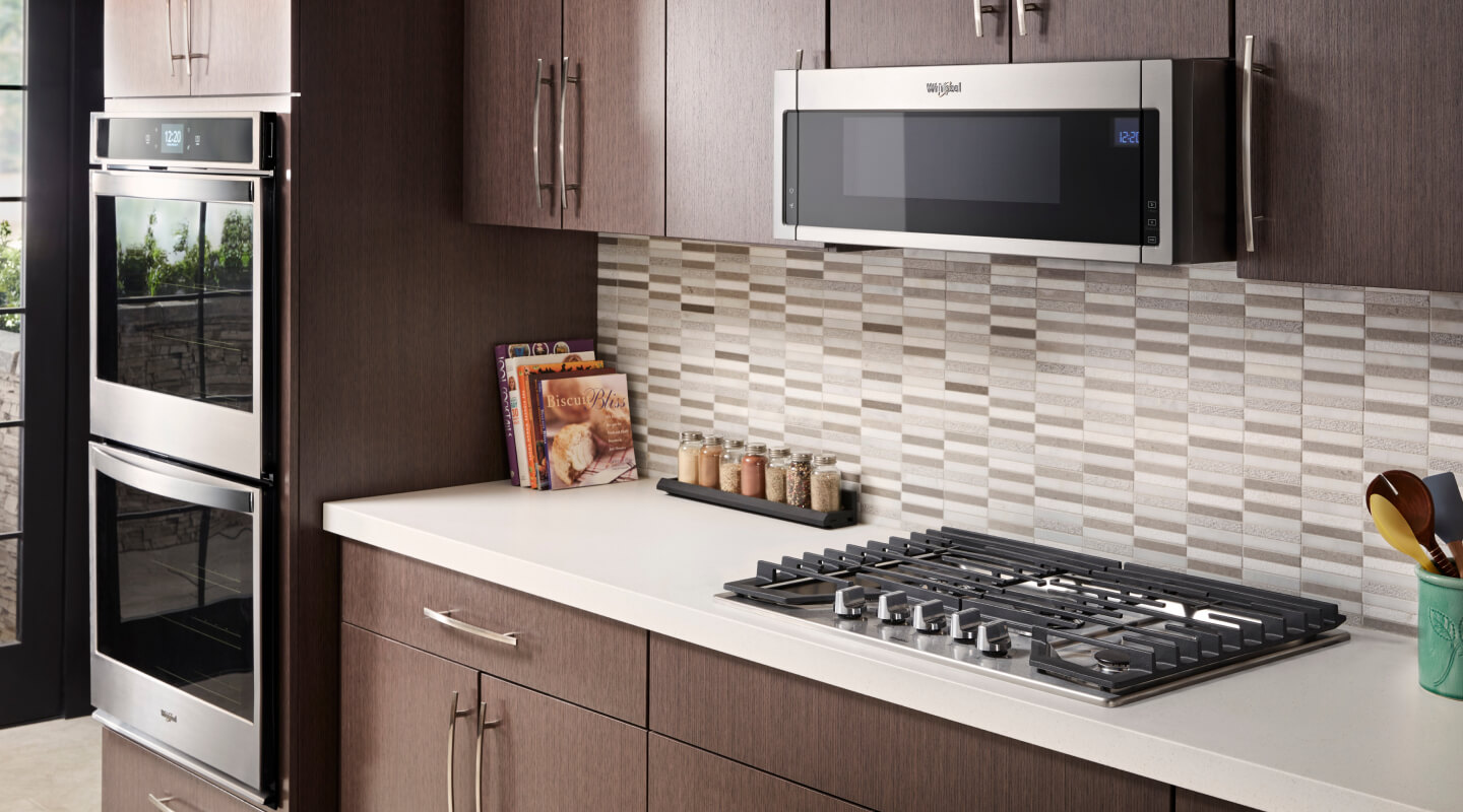 Whirlpool® gas cooktop in front of gray and white tile backsplash