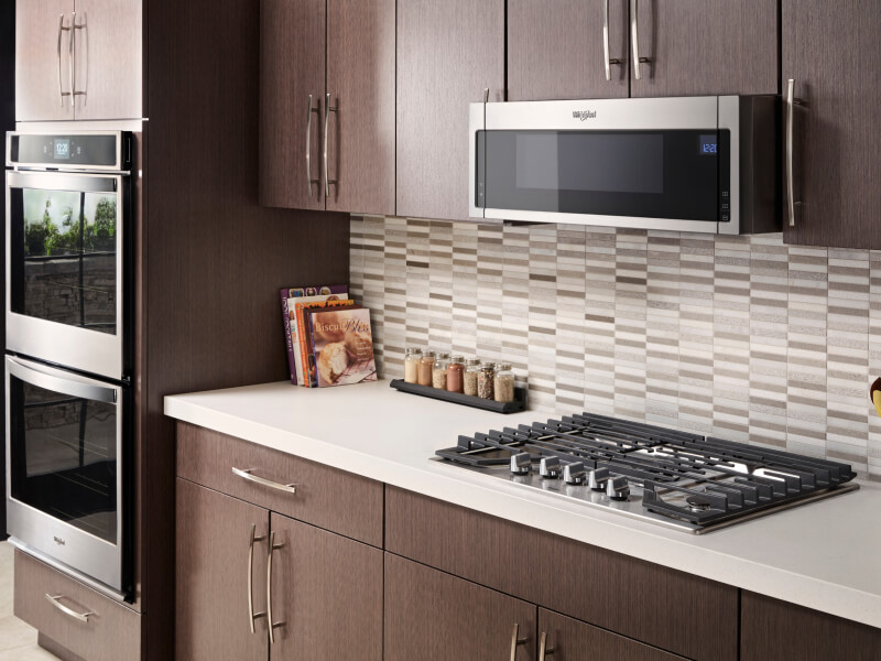 Whirlpool® gas cooktop in front of gray and white tile backsplash