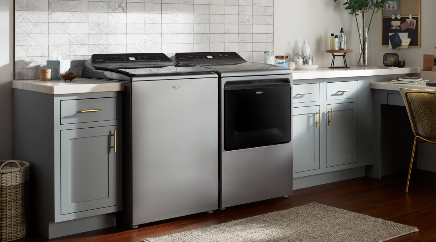 A stainless steel, top load washer and dryer set by Whirlpool brand