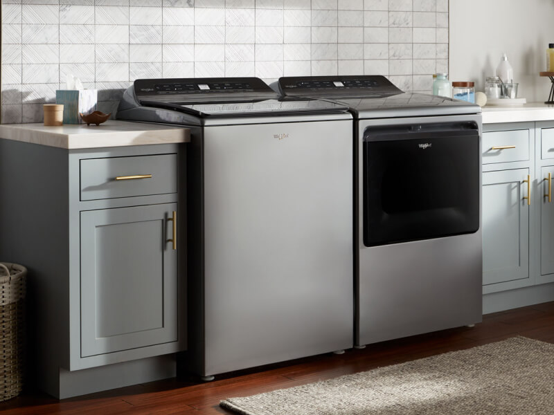 A stainless steel, top load washer and dryer set by Whirlpool brand