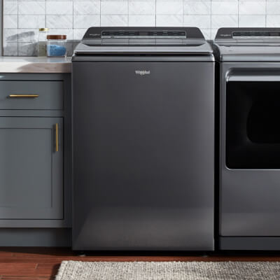 A Whirlpool® Top Load Washer in a laundry room