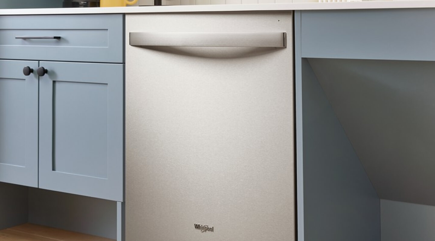 Flush dishwasher against blue cabinetry