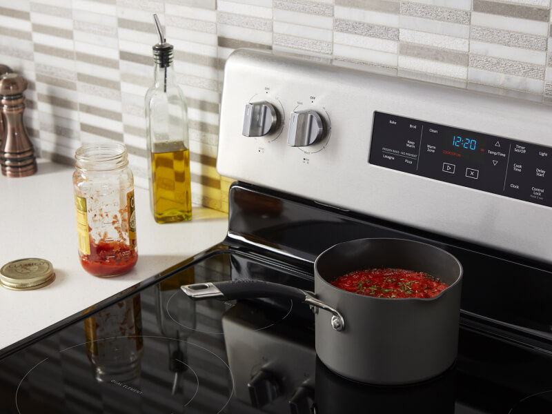 A pan of pasta simmering on a stove