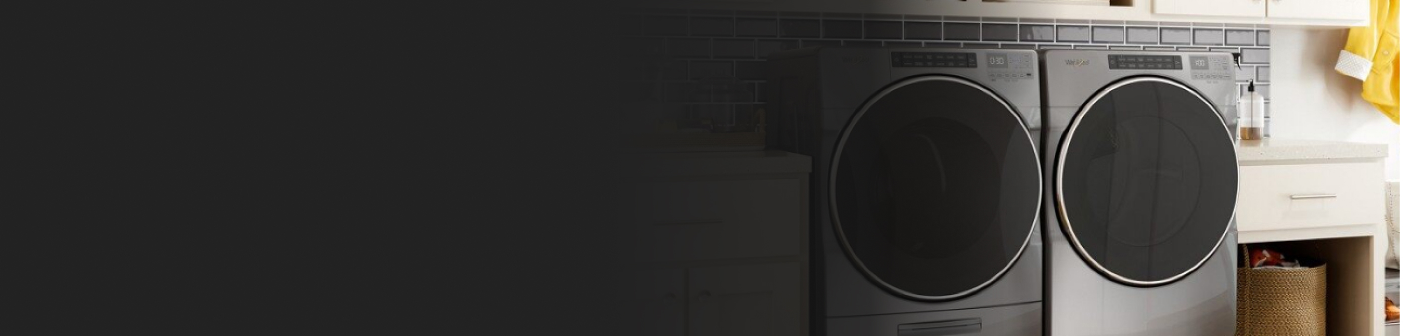 Front load chrome washer and dryer in a laundry room