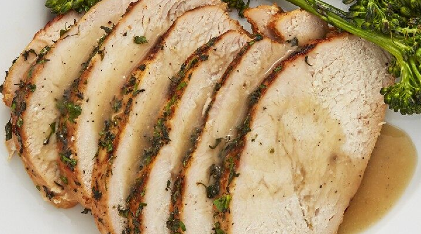Sliced turkey with gravy garnished with herbs Sliced turkey with gravy garnished with herbs