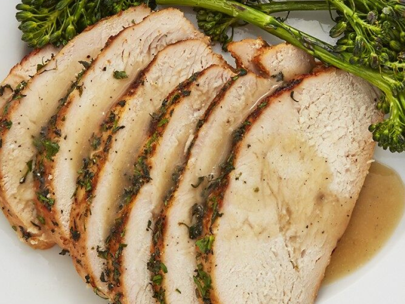 Sliced turkey with gravy garnished with herbs Sliced turkey with gravy garnished with herbs