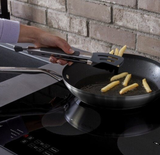 French fries being cooked on an electric stovetop