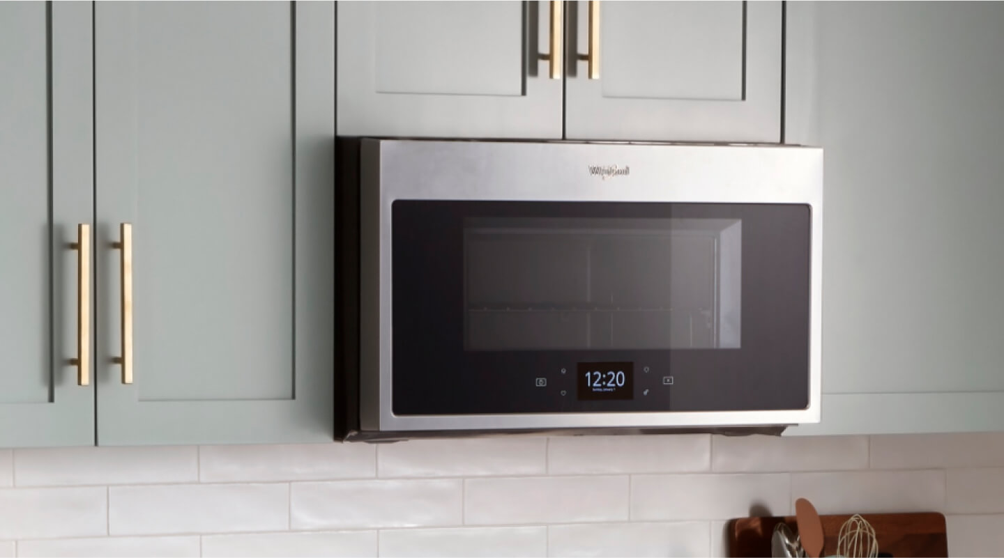 Whirlpool® Microwave set in light green cabinetry