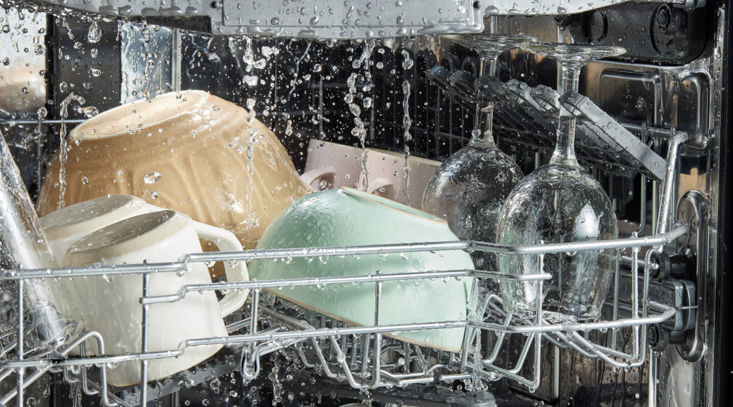Water droplets falling on dishes in a dishwasher