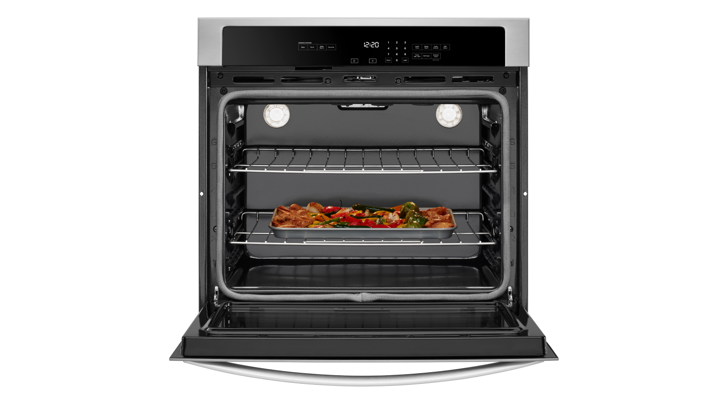 A Whirlpool® wall oven with a baking sheet of food inside
