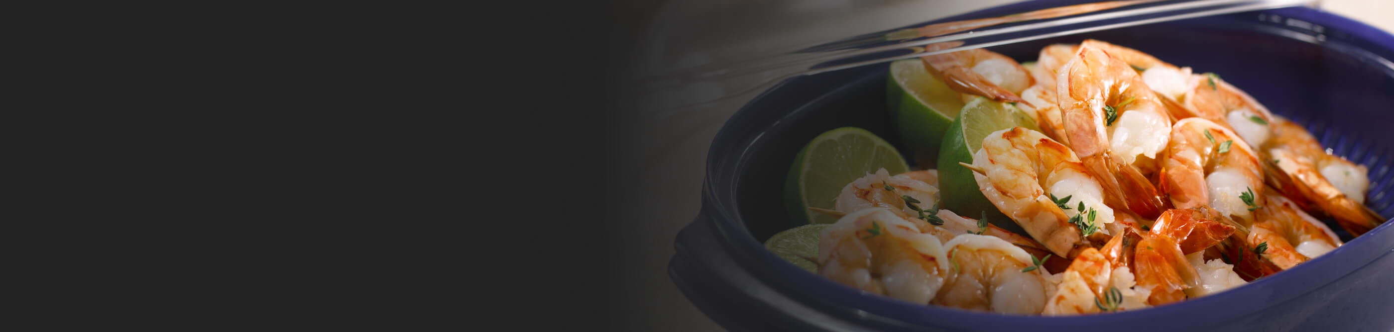 Steamed shrimp with herbs and lime in a blue dish