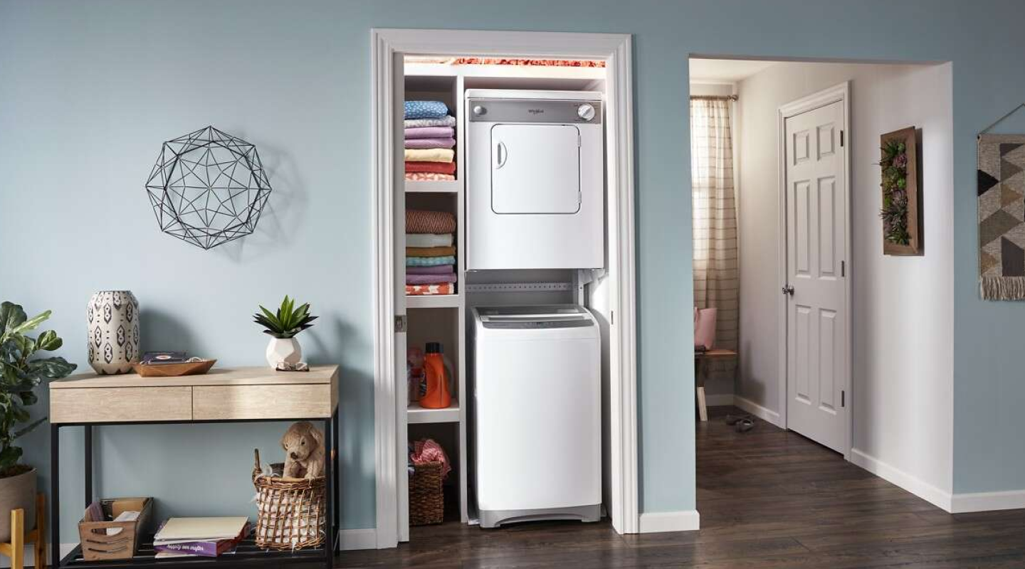 Stacked, Whirlpool® Compact Washer and Dryer in a closet with shelving