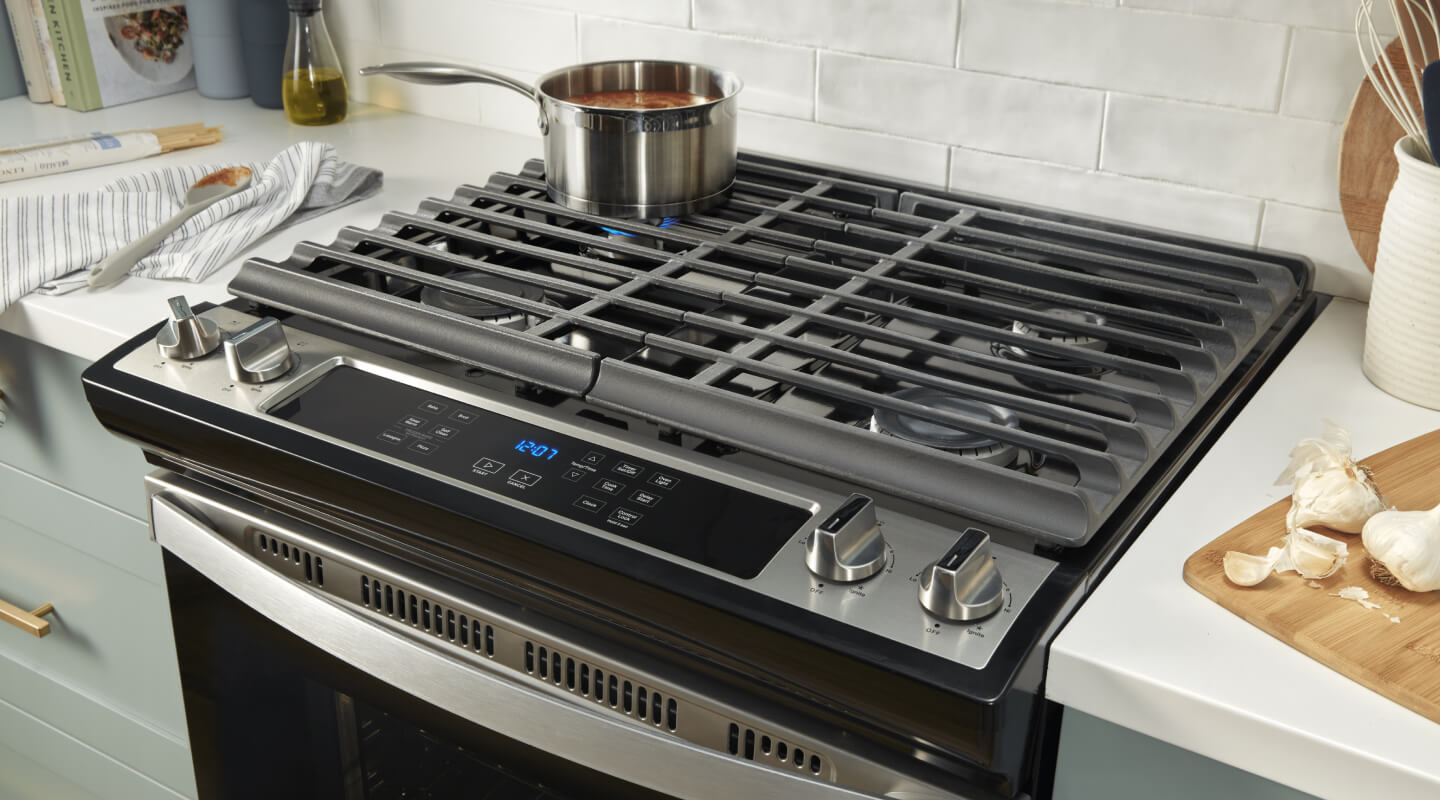 Pot of food simmering on a gas stovetop