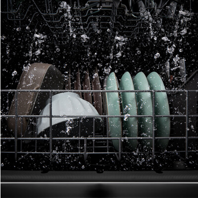 Dishes being washed inside a dishwasher